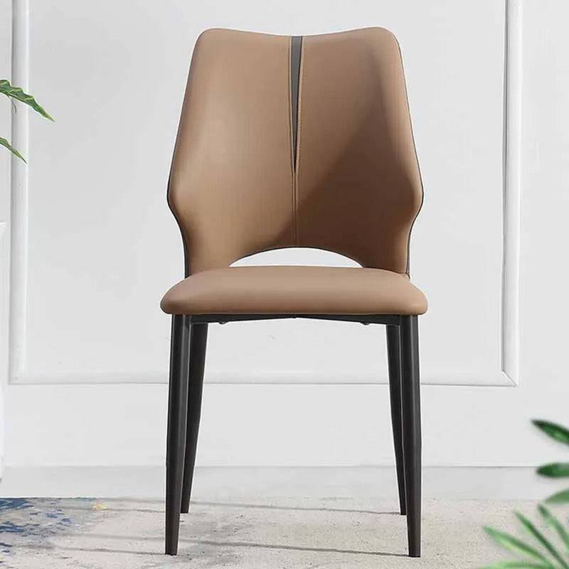 a brown chair sitting next to a potted plant