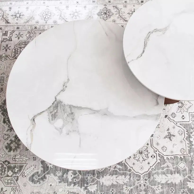 two white marble tables on a rug