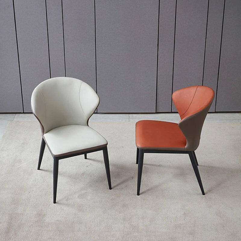 a couple of chairs sitting on top of a carpet