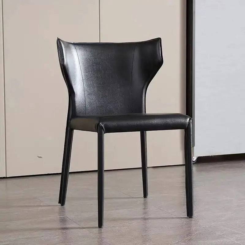 a black chair sitting on top of a hard wood floor