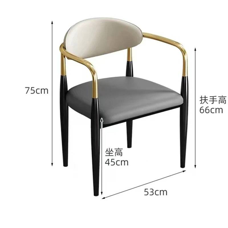 a white and black chair with a gold frame