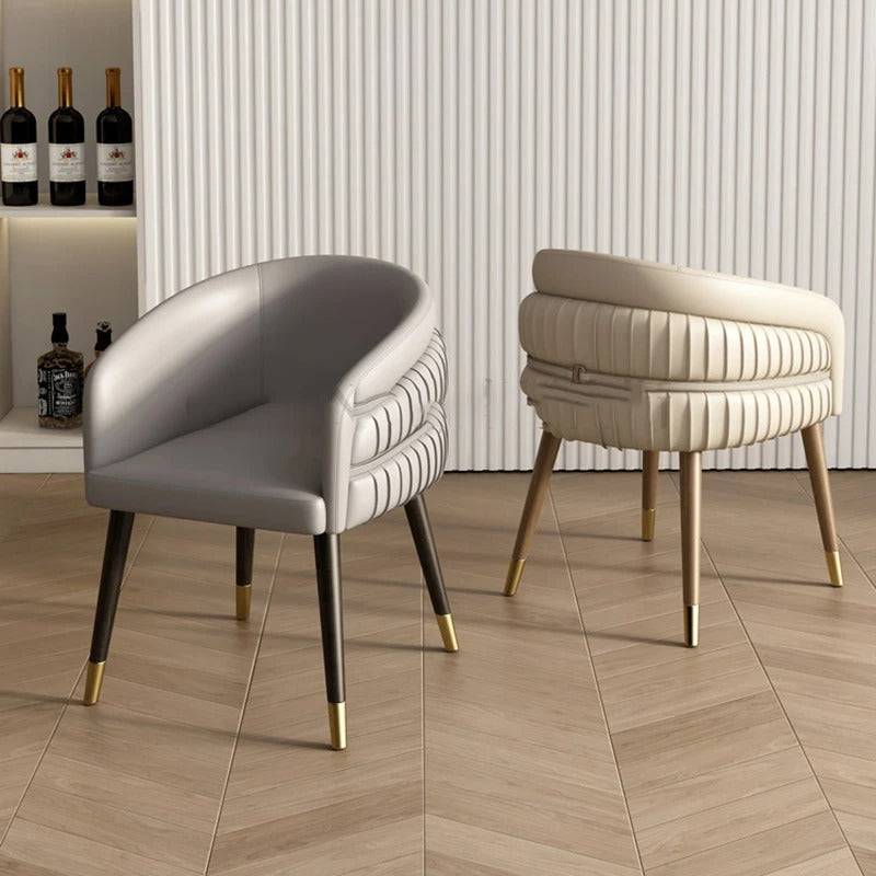 a couple of chairs sitting on top of a hard wood floor