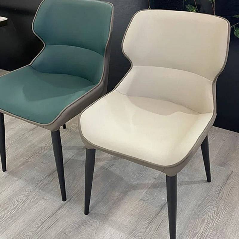 a couple of chairs sitting on top of a hard wood floor