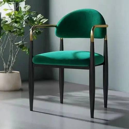 a green chair sitting next to a potted plant