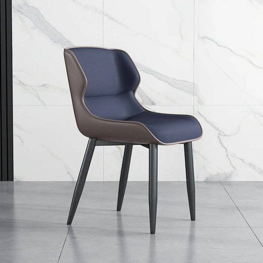 a blue and brown chair sitting in front of a marble wall