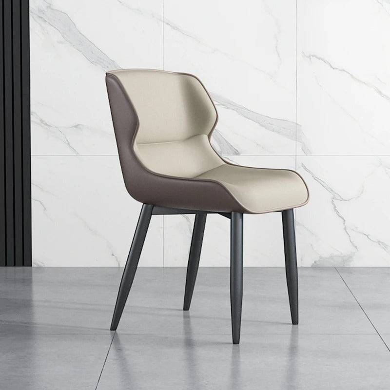 a white chair sitting in front of a marble wall