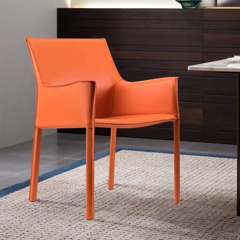 an orange chair sitting on top of a rug