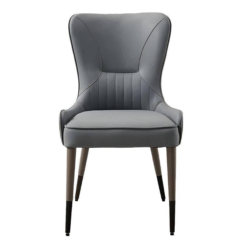 a gray leather chair with wooden legs