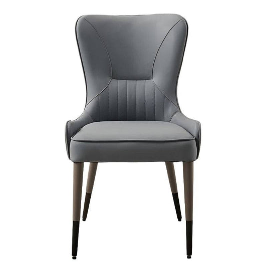 a gray leather chair with wooden legs
