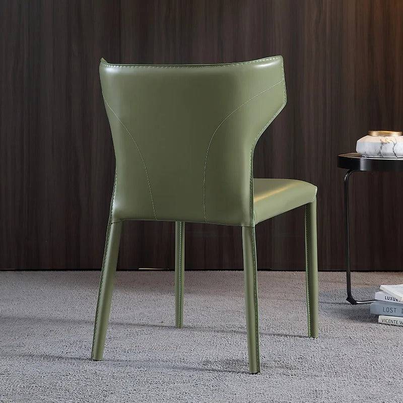 a green chair sitting next to a table