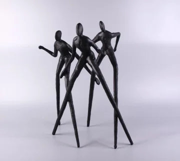 3 men standing sculpture table decor