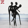 3 men standing sculpture table decor
