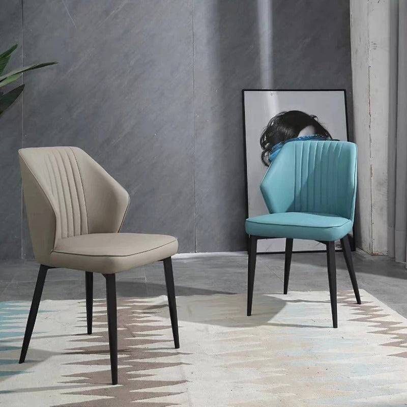 a couple of chairs sitting on top of a rug