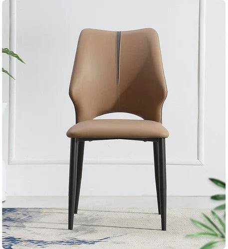 a chair with a brown seat and a plant in the corner