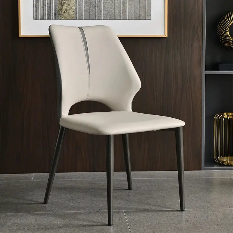 a white chair sitting in a room next to a book shelf