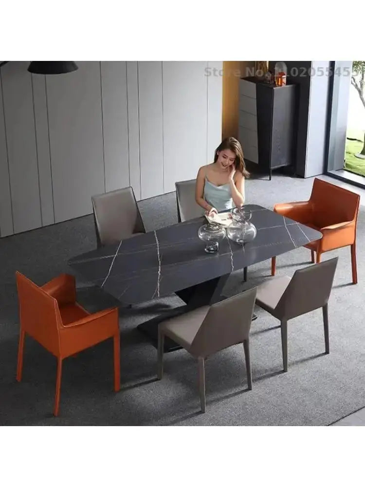 a woman sitting at a table with chairs around it