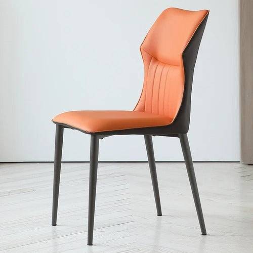 an orange and black chair sitting on a hard wood floor