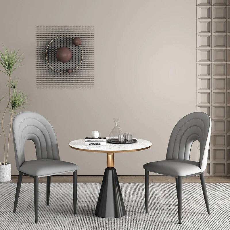 a table with two chairs and a vase on top of it