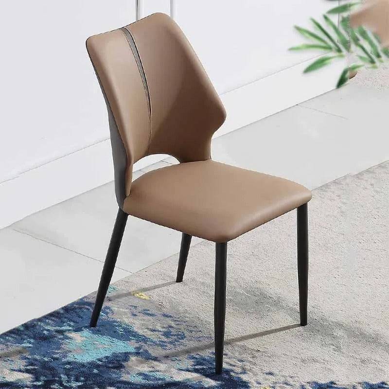 a brown chair sitting on top of a rug