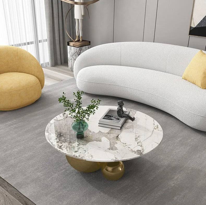 a living room with a white couch and a marble coffee table